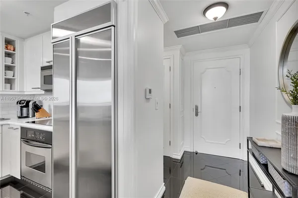 a kitchen with a refrigerator and a sink