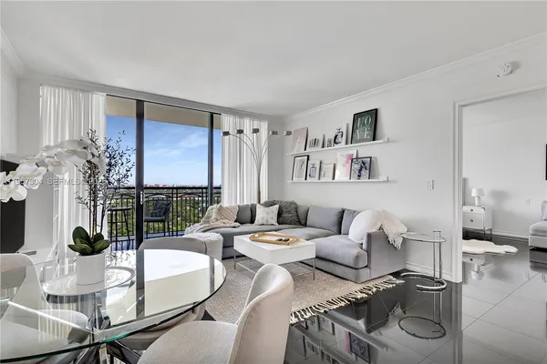 a living room with furniture and a floor to ceiling window