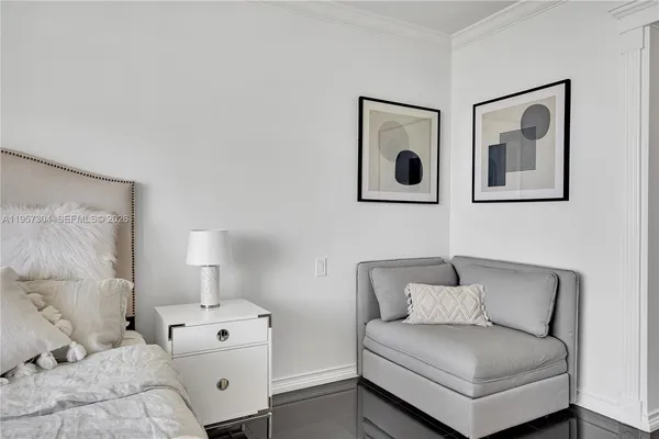 a bedroom with a bed and painting on the wall