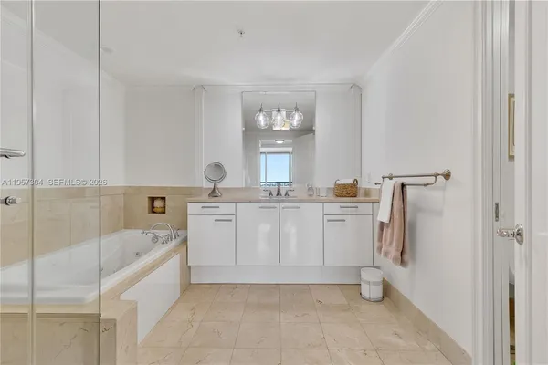 a bathroom with a tub sink and mirror
