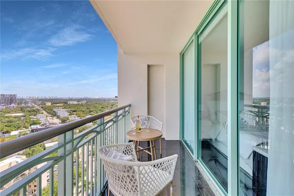a view of a balcony with furniture