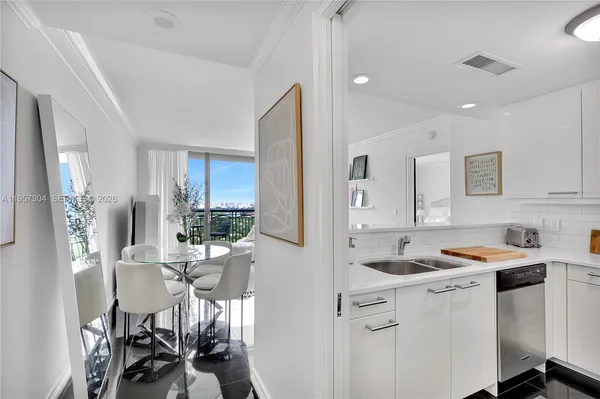 a kitchen that has a lot of cabinets a sink and appliances in it
