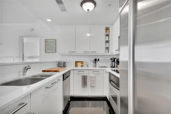 a kitchen with stainless steel appliances granite countertop a sink and cabinets