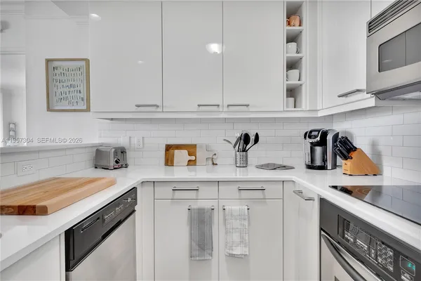 a kitchen with stainless steel appliances granite countertop a sink and cabinets