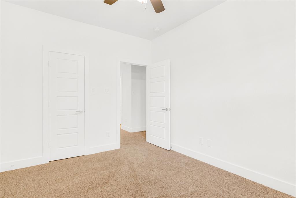 3676 Rickshaw Drive, Unit A Dallas, TX 75229 - Photo 14 of 21 Large secondary bedroom with in-room closet has lots of natural light and opens out to hallway and bathroom.