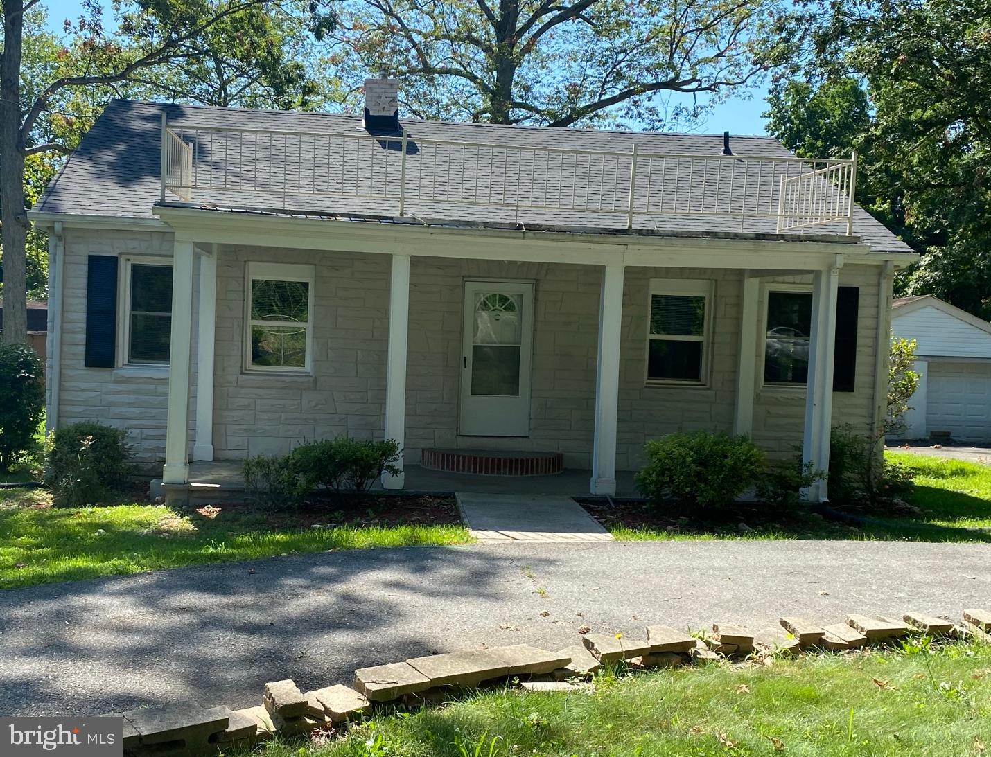 Front of house with circular driveway.