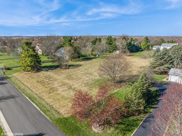a view of a field with a building in background
