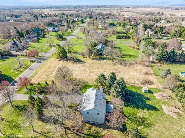 an aerial view of residential houses with outdoor space