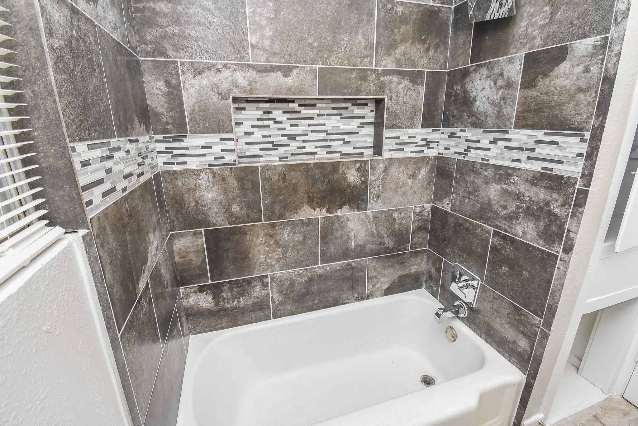 6223 Wayland Street Houston, TX 77021 - Photo 13 of 20 Updated shower surround with modern tile accent.