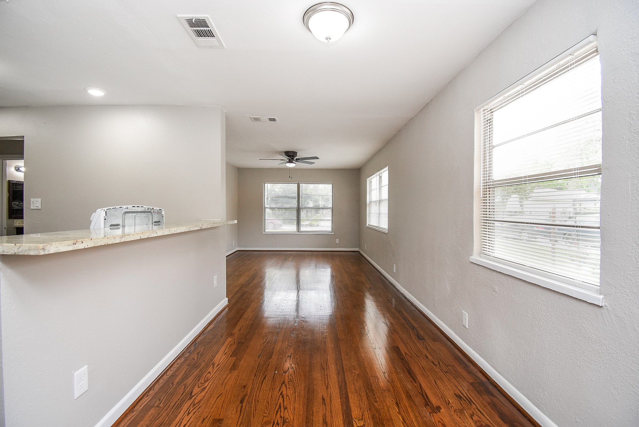 6223 Wayland Street Houston, TX 77021 - Photo 6 of 20 Refinished hardwood floors and granite tiered breakfast bar.