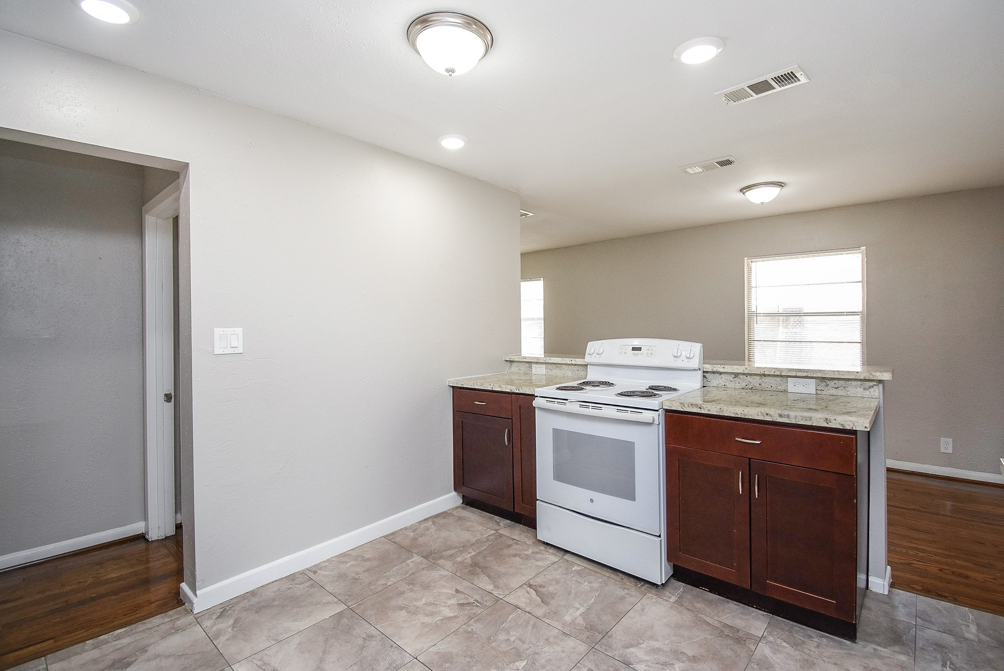 6223 Wayland Street Houston, TX 77021 - Photo 7 of 20 Kitchen boasts wood toned cabinets and classic white appliances.