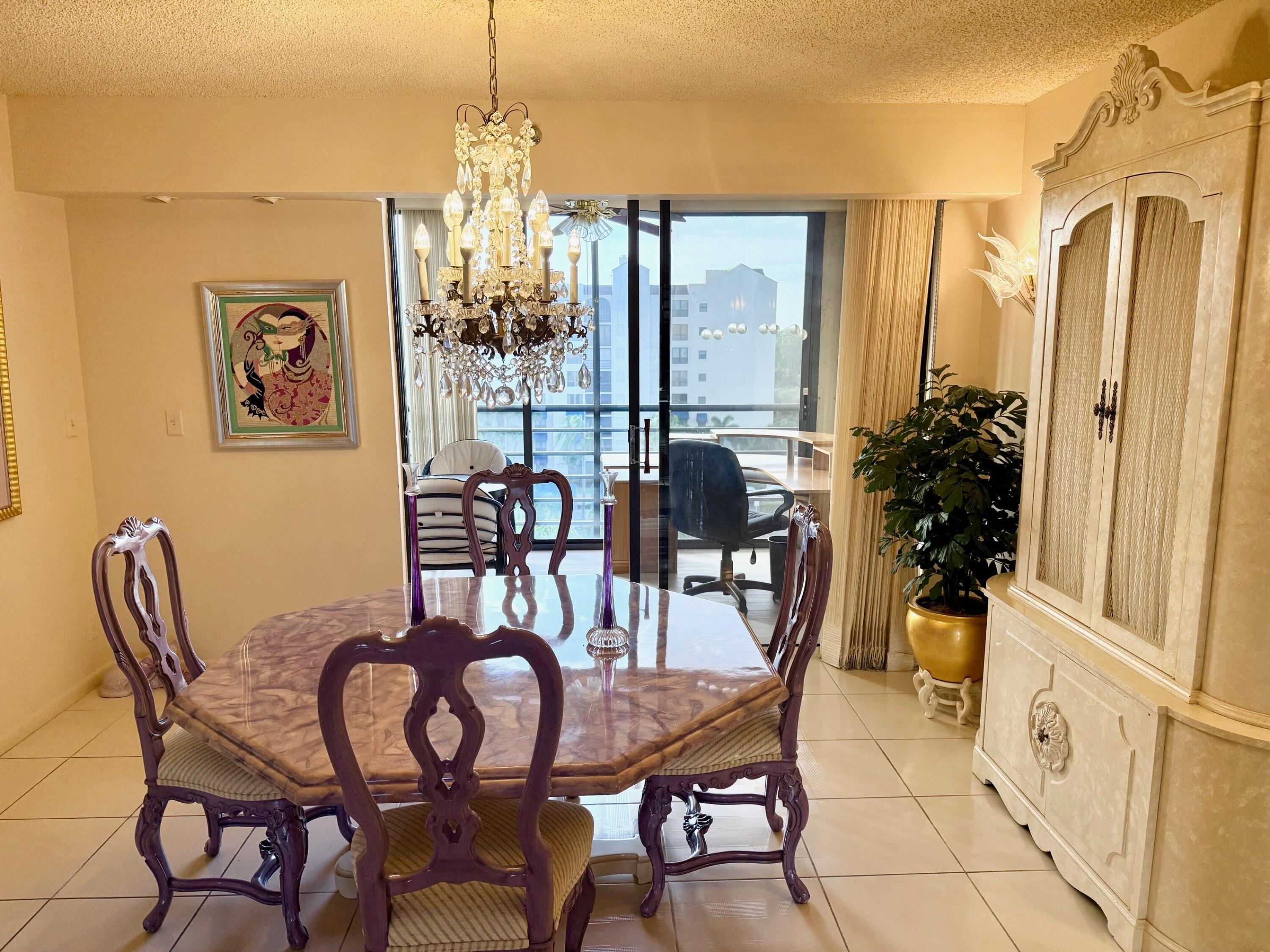 7564 Regency Lake Drive, Unit 702 Boca Raton, FL 33433 - Photo 13 of 40 a dining room with furniture window and wooden floor
