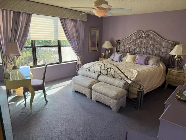 a bedroom with a bed chair and window