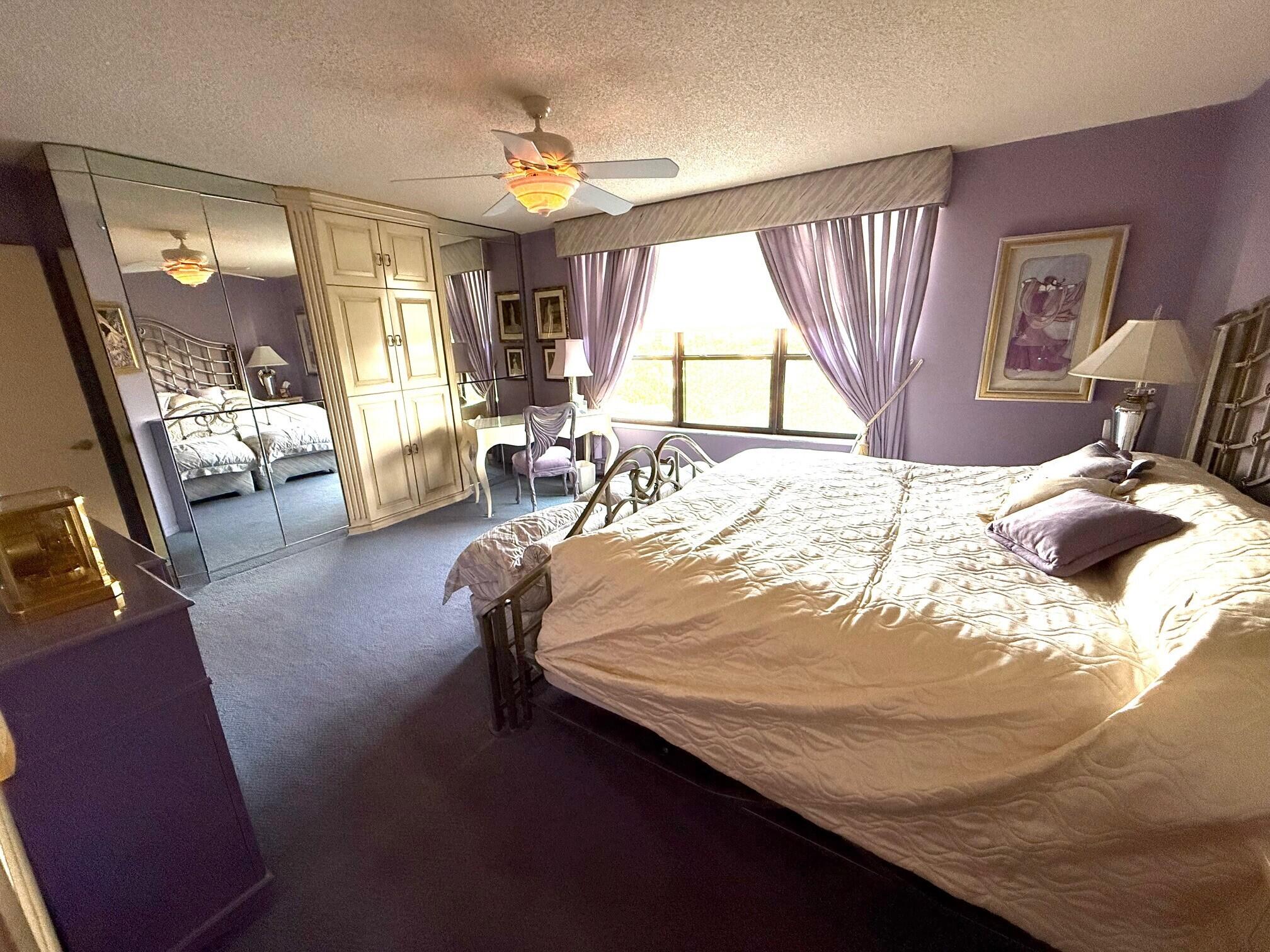 7564 Regency Lake Drive, Unit 702 Boca Raton, FL 33433 - Photo 18 of 40 a bed sitting in a bedroom next to a window