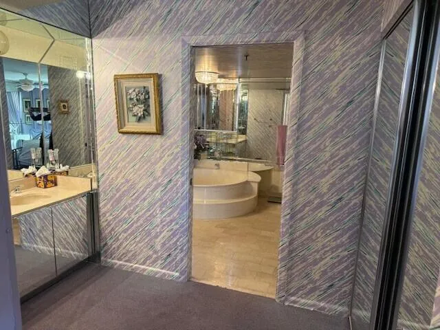 a bathroom with a tub shower and sink