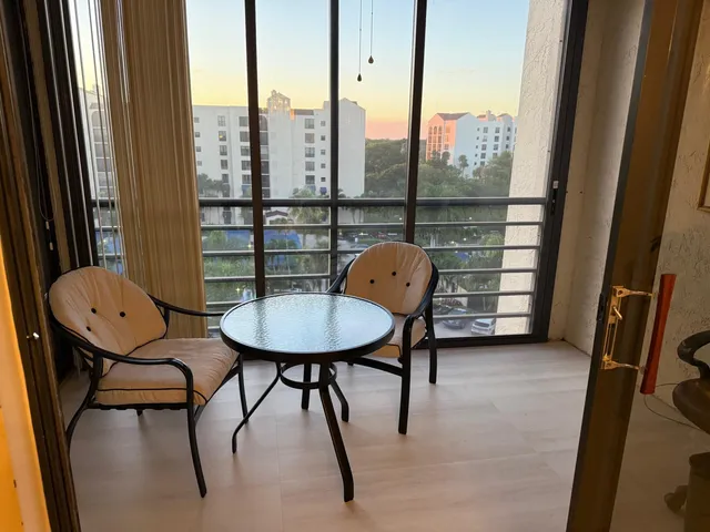 a view of a room with furniture and a window