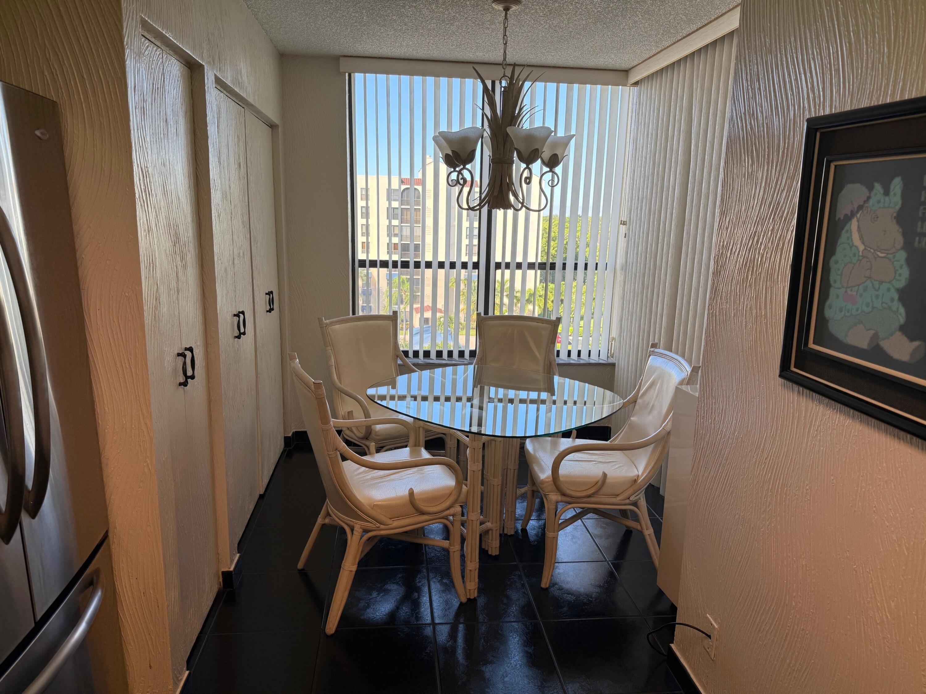 7564 Regency Lake Drive, Unit 702 Boca Raton, FL 33433 - Photo 5 of 40 a view of a livingroom with furniture window and wooden floor