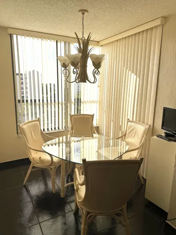 a dining room with furniture and window