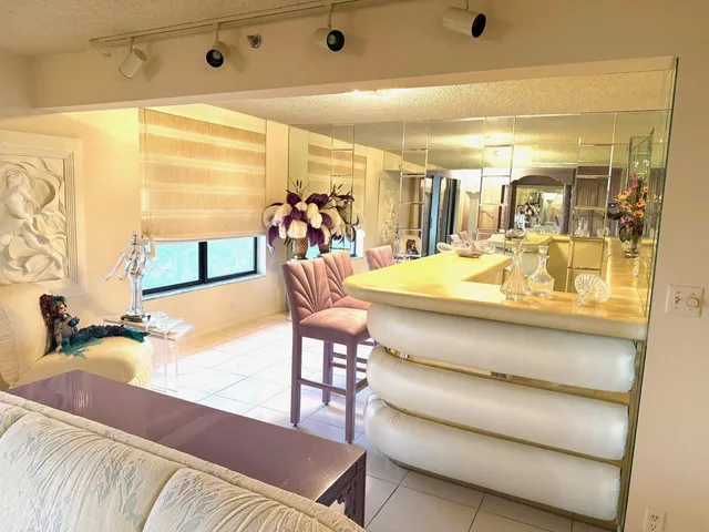 a view of a dining room with furniture and a large window