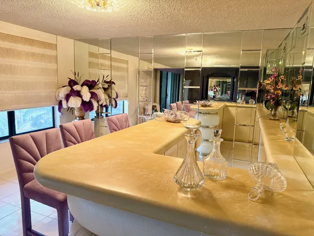 a view of a dining room with furniture and a chandelier