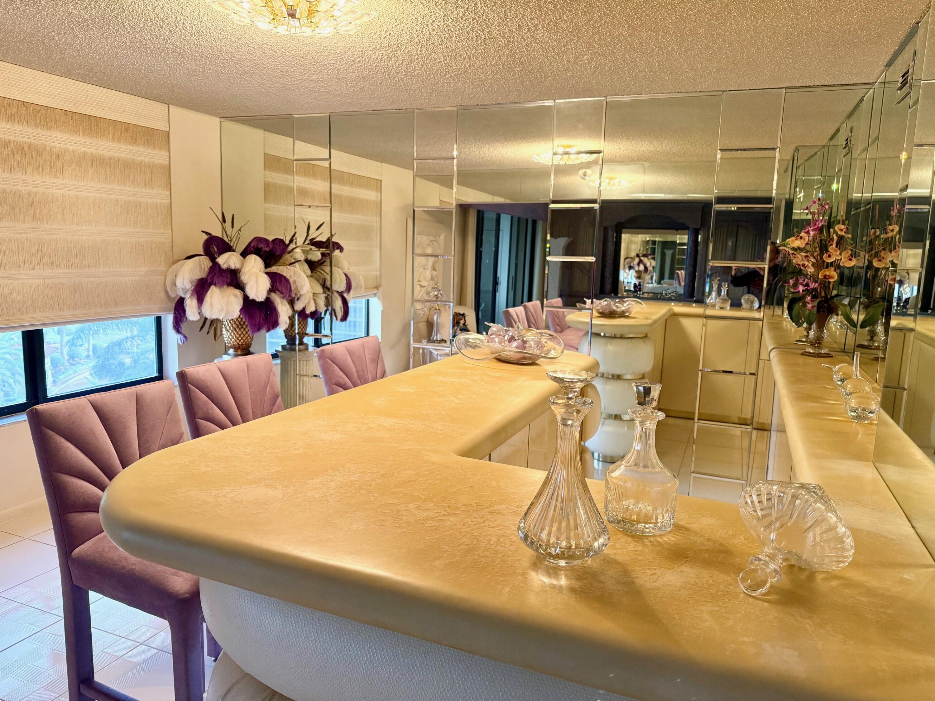 7564 Regency Lake Drive, Unit 702 Boca Raton, FL 33433 - Photo 8 of 40 a view of a dining room with furniture and a chandelier