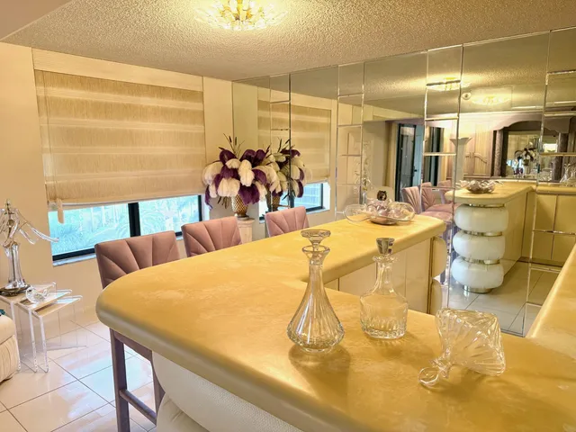 a view of a dining room with furniture and a chandelier