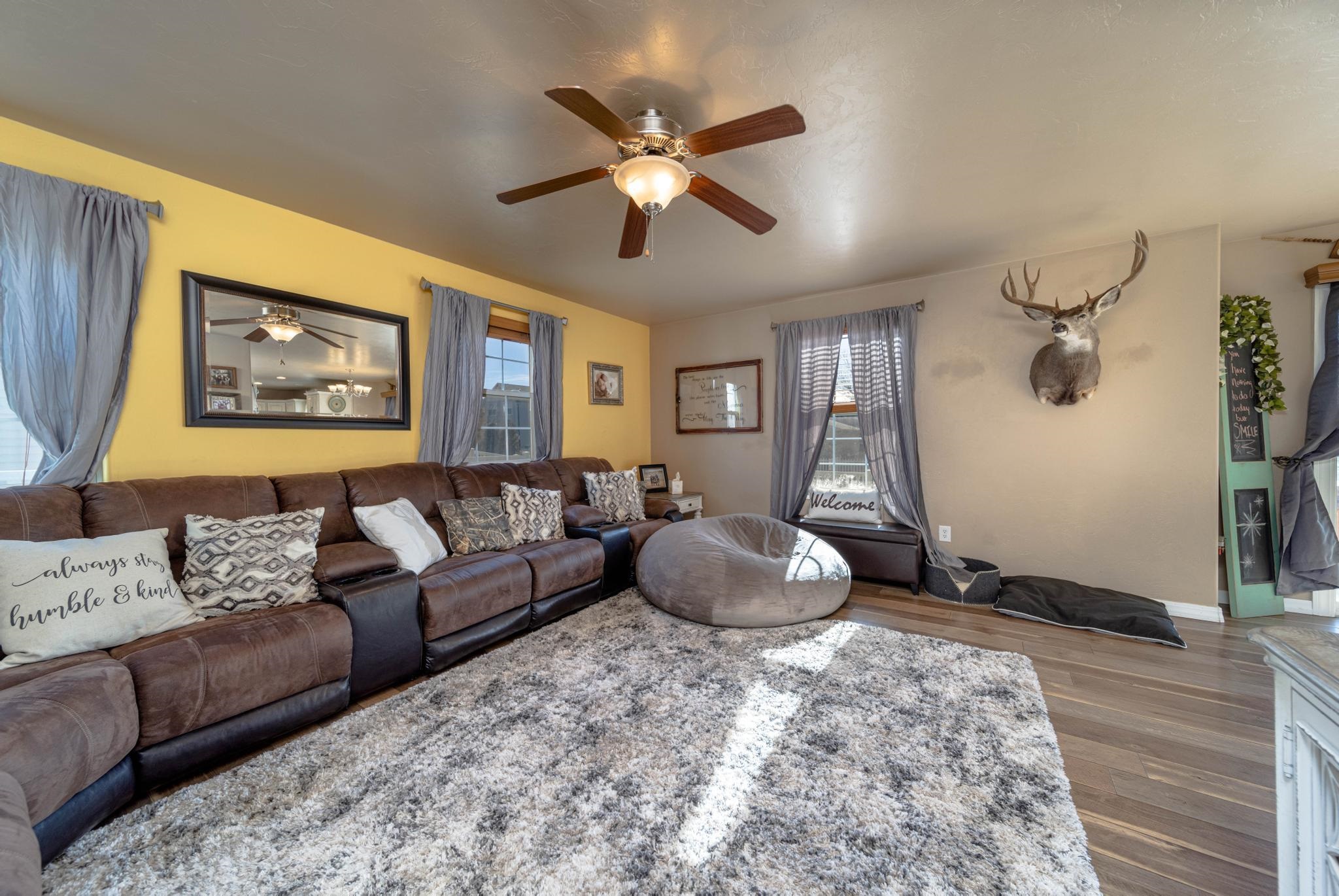 1124 West Addington Lane Fruita, CO 81521 - Photo 11 of 25 a living room with furniture and a large window