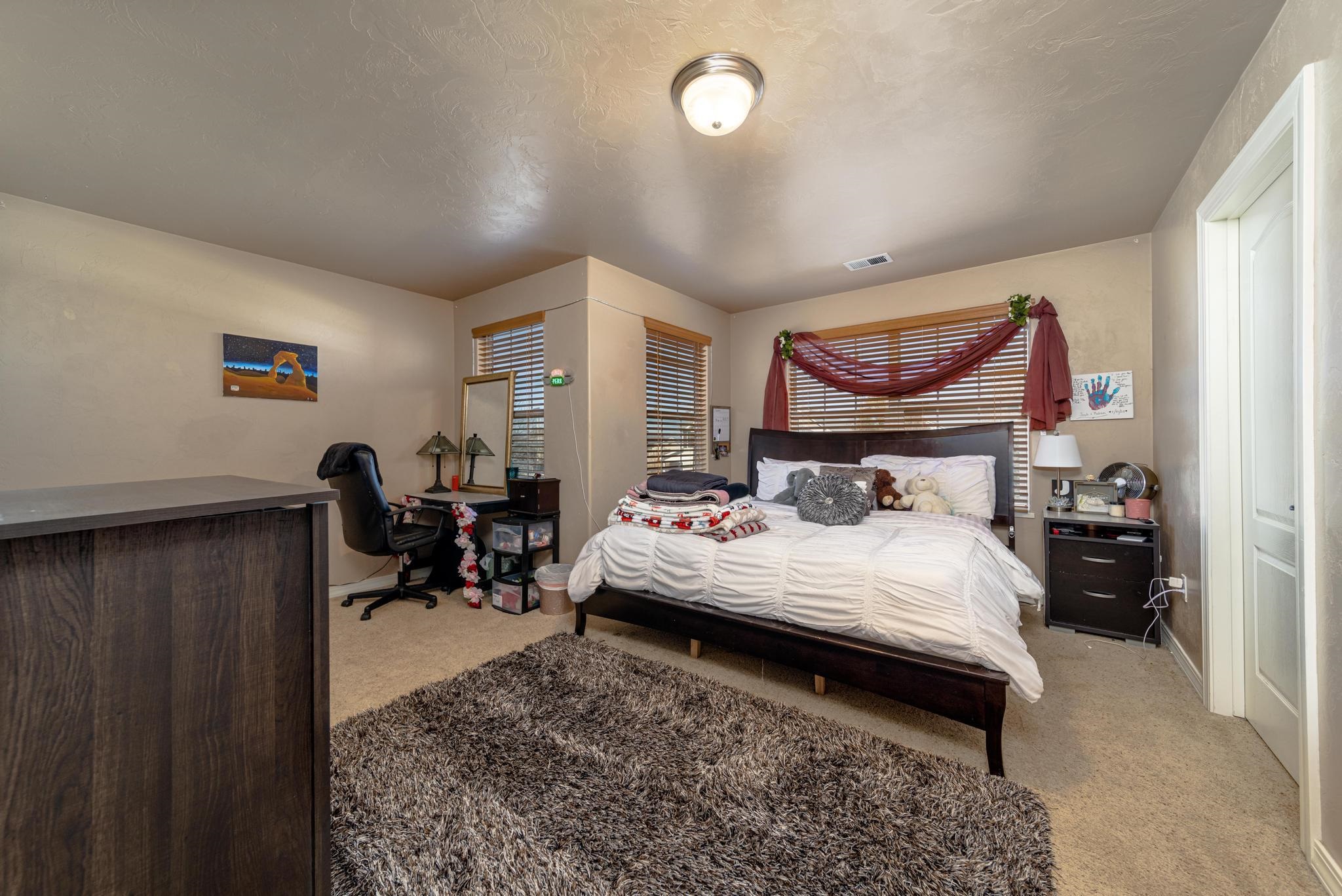 1124 West Addington Lane Fruita, CO 81521 - Photo 16 of 25 a bed room with a bed and furniture