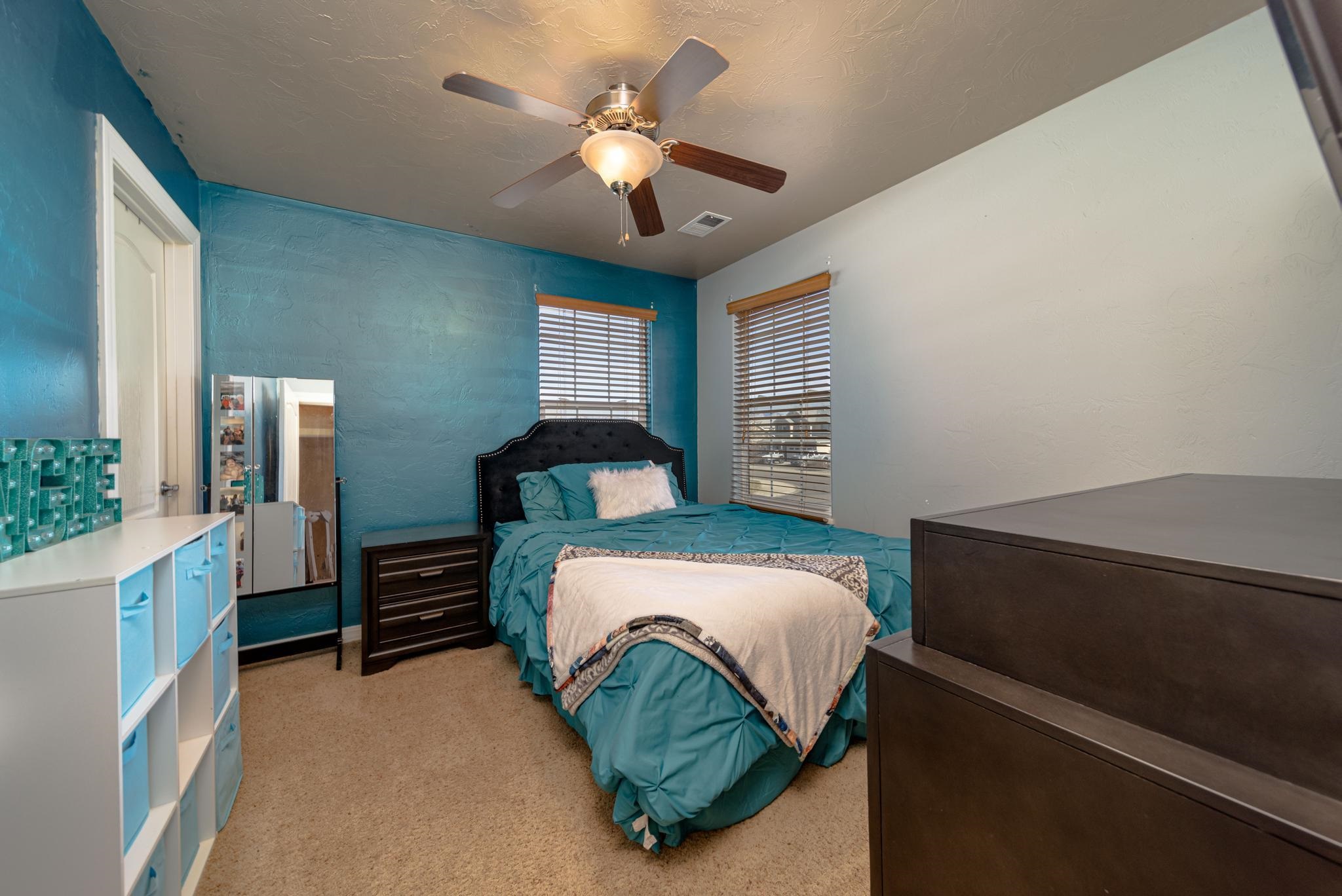 1124 West Addington Lane Fruita, CO 81521 - Photo 18 of 25 a bedroom with a bed dresser and a window
