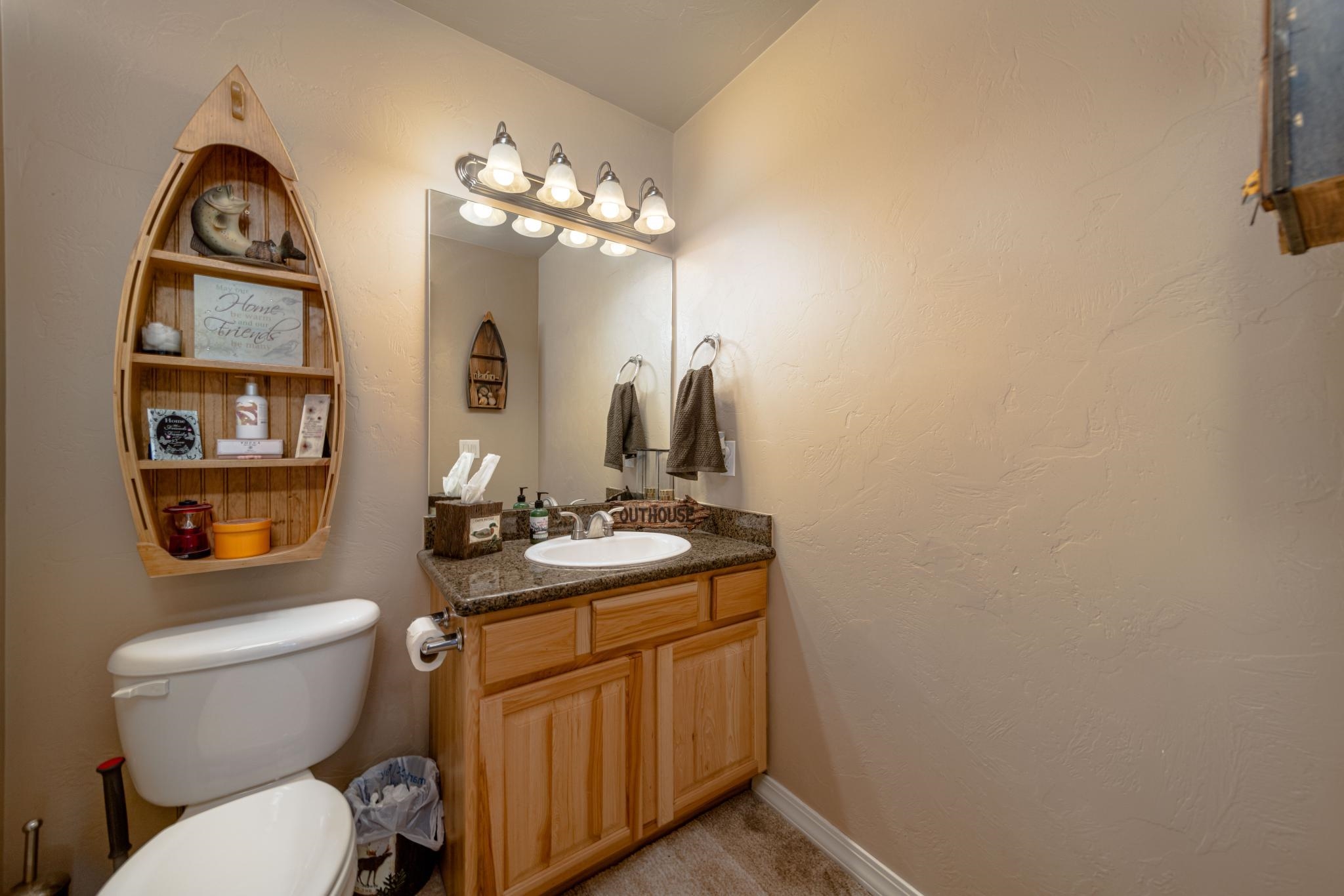 1124 West Addington Lane Fruita, CO 81521 - Photo 21 of 25 a bathroom with a toilet a sink and a mirror