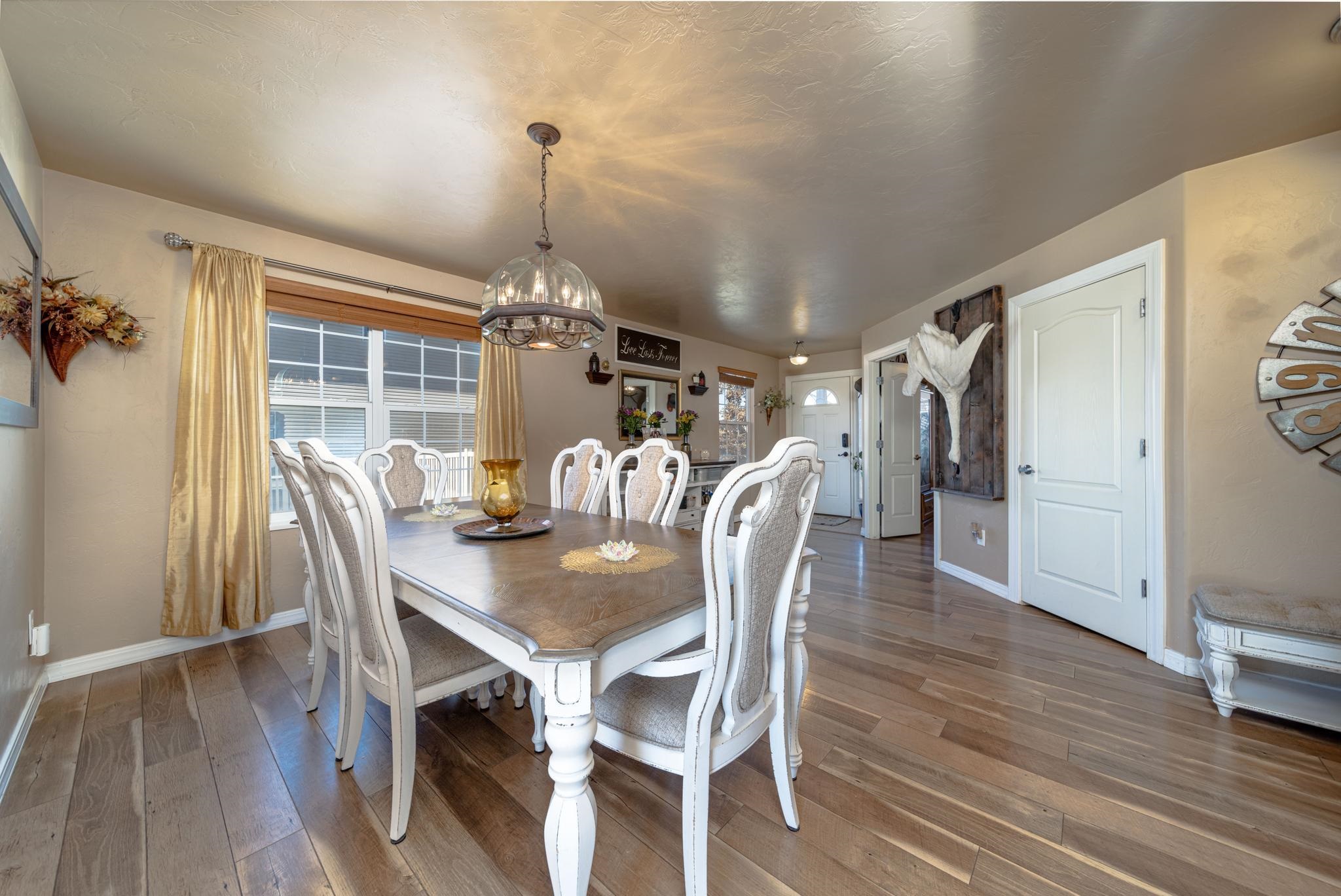 1124 West Addington Lane Fruita, CO 81521 - Photo 5 of 25 a view of a dining room with furniture window and wooden floor