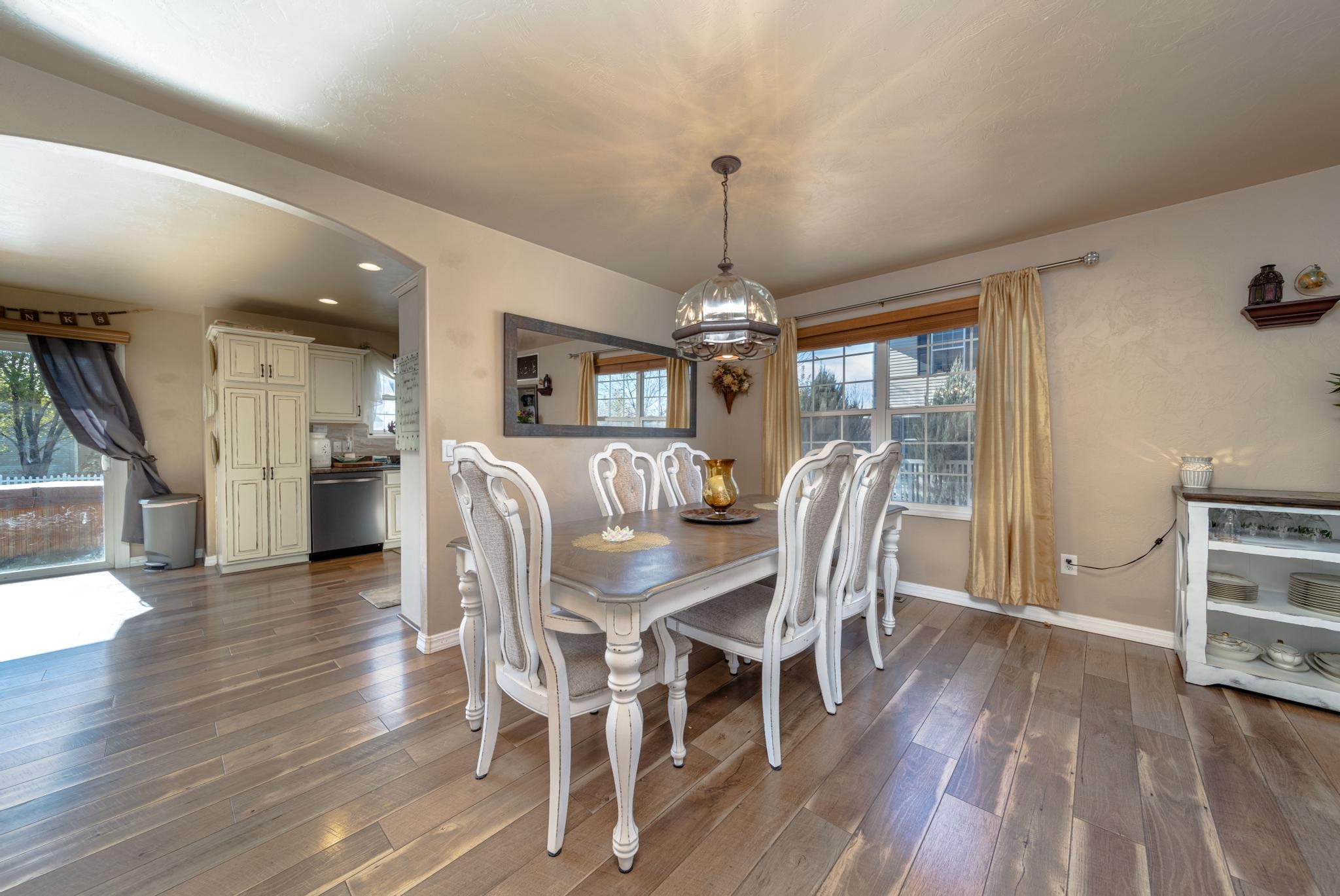 1124 West Addington Lane Fruita, CO 81521 - Photo 6 of 25 a view of a dining room with furniture window and wooden floor
