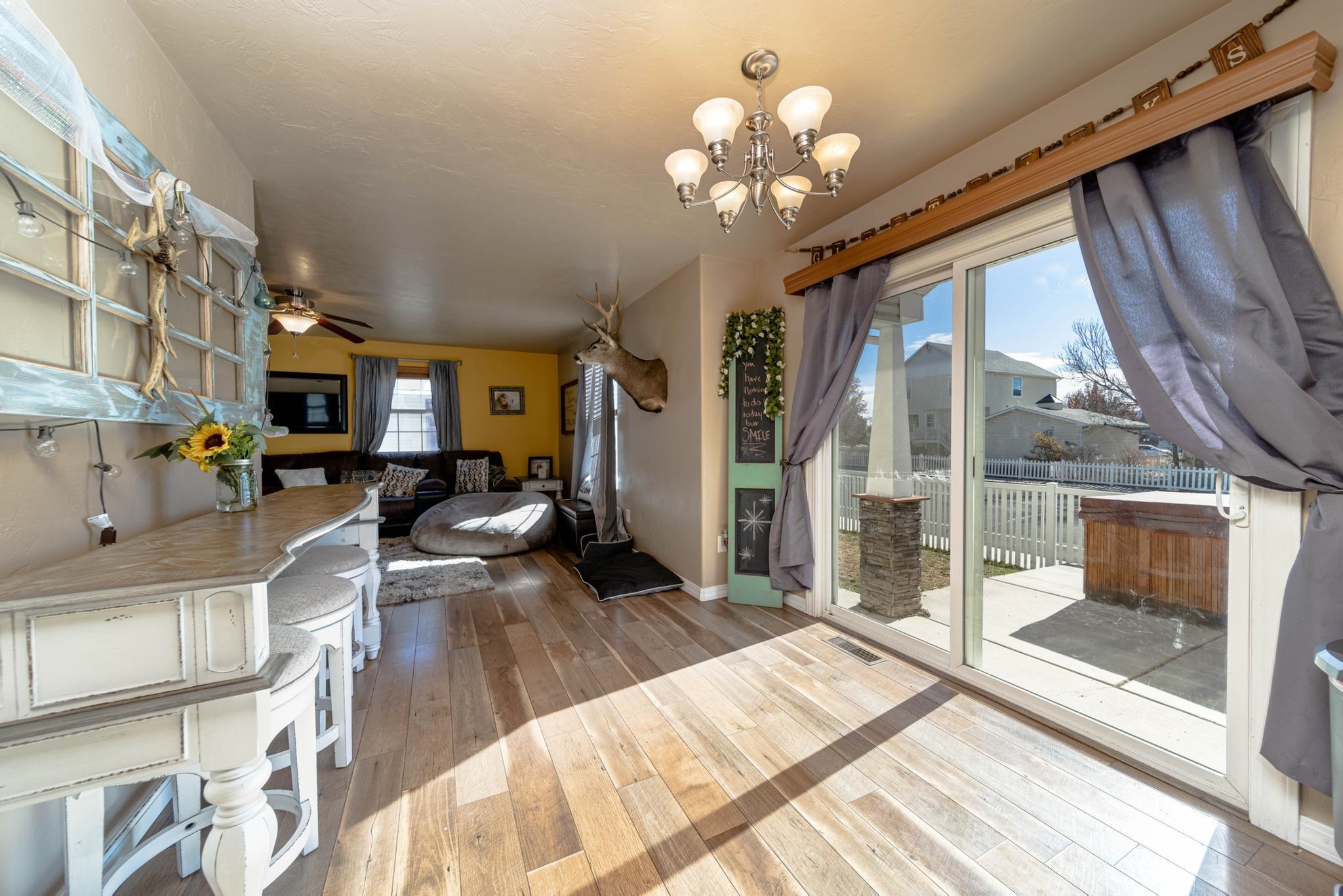 1124 West Addington Lane Fruita, CO 81521 - Photo 8 of 25 a spacious bedroom with a large bed and a chandelier