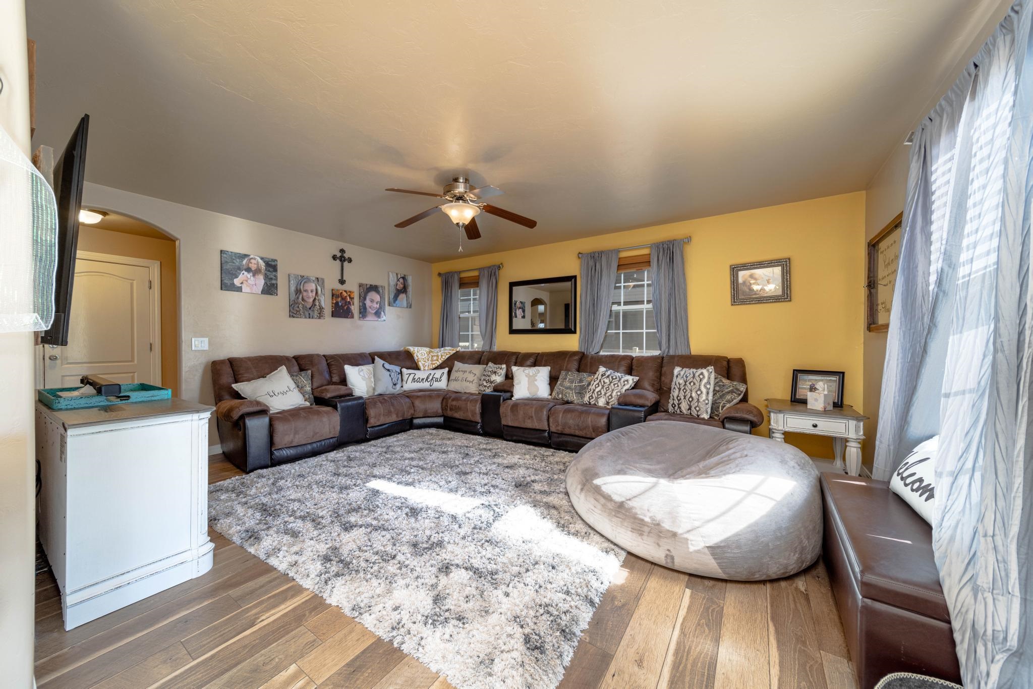 1124 West Addington Lane Fruita, CO 81521 - Photo 10 of 25 a living room with furniture and a chandelier