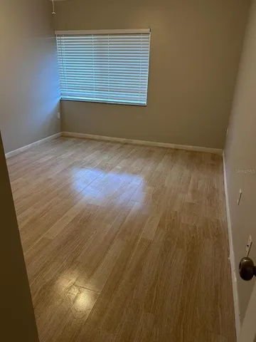 an empty room with wooden floor