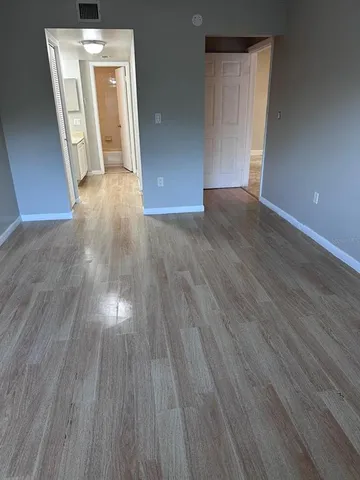 a view of hallway with wooden floor