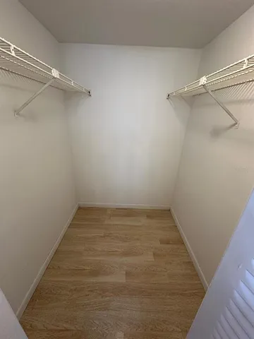 a view of hallway with wooden floor