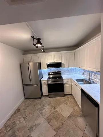 a kitchen with stainless steel appliances a stove and a refrigerator