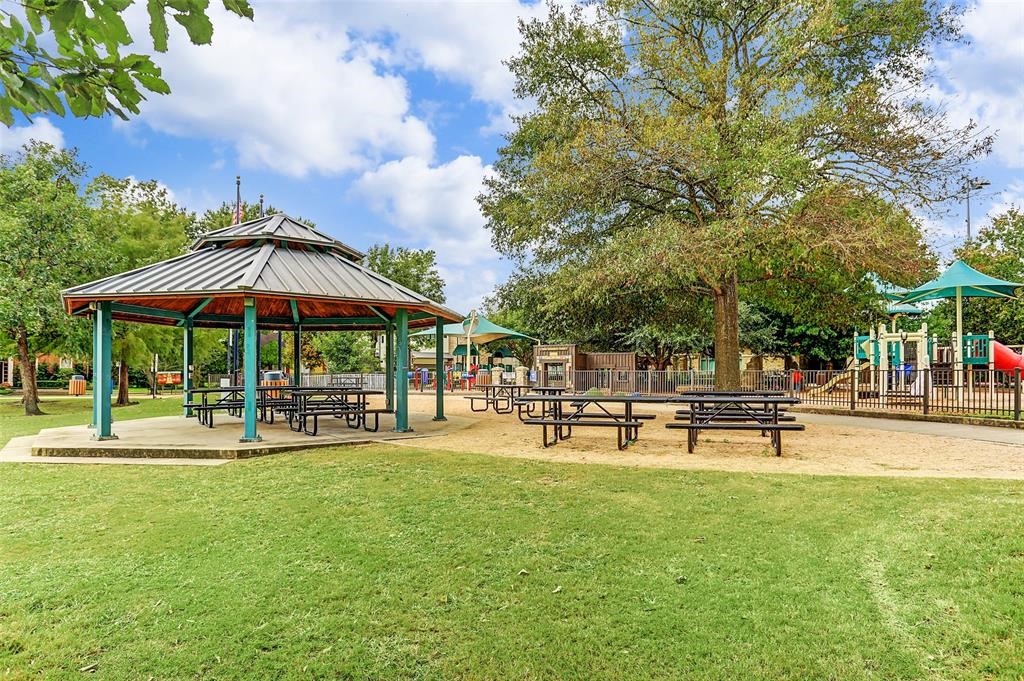 5920 Lake Street Houston, TX 77005 - Photo 21 of 25 a view of a swimming pool with lawn chairs under an umbrella