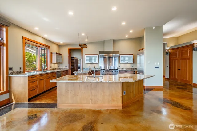a living room with stainless steel appliances granite countertop lots of counter top space and furniture