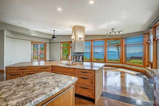 a kitchen with stainless steel appliances granite countertop a sink and a stove
