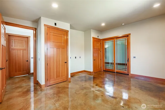 an empty room with windows and closet