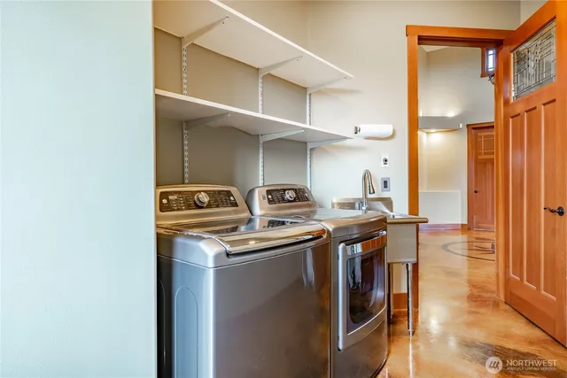 a view of a patio with a table and chairs under an umbrella