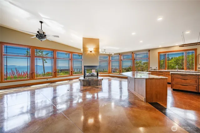 a view of a living room and kitchen with a large window