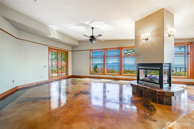 a living room with fireplace furniture and a large window