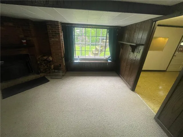 a view of empty room with a fireplace