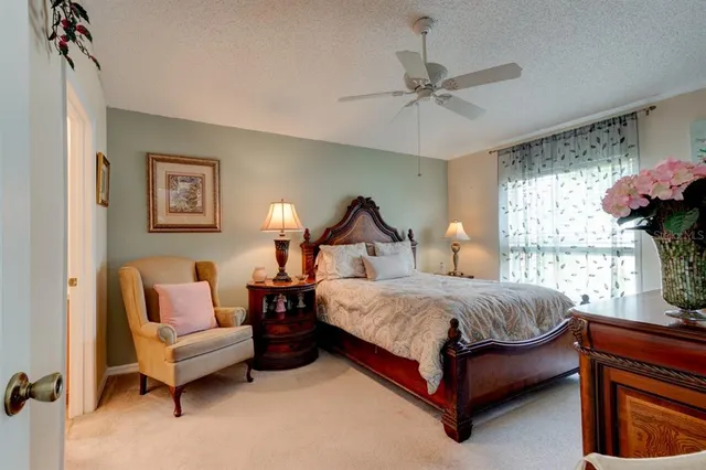 a bedroom with a bed couch and window