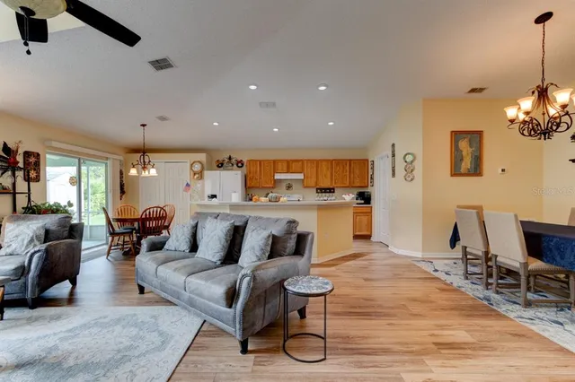 a living room with furniture and kitchen view
