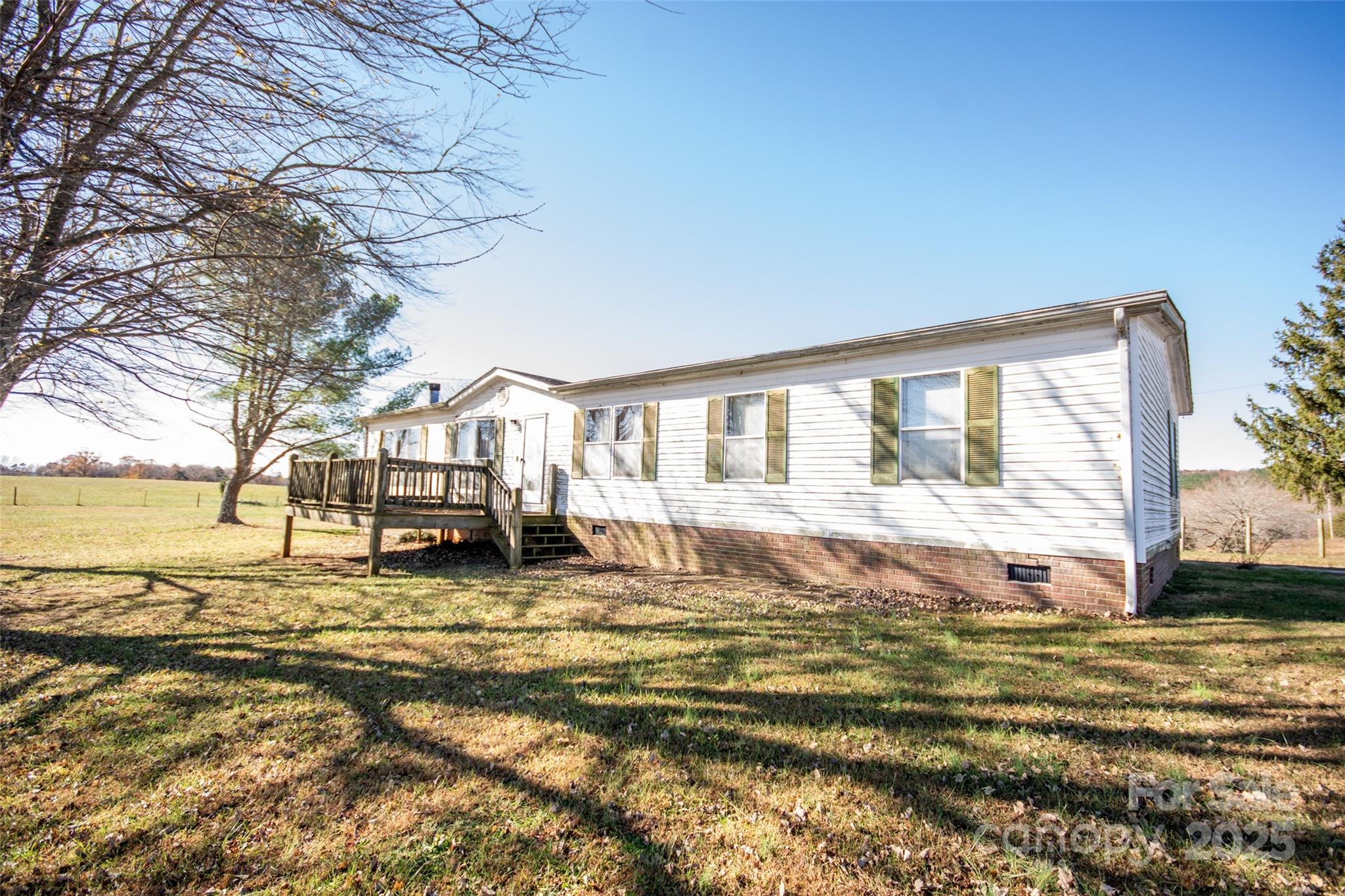 334 Myers Mill Road Statesville, NC 28625 - Photo 29 of 35 a view of a swimming pool with lawn chairs under an umbrella