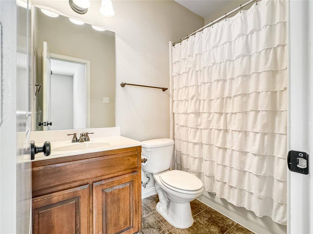 401 Varnum Way Fairview, TX 75069 - Photo 25 of 33 a bathroom with a sink a toilet and shower curtain